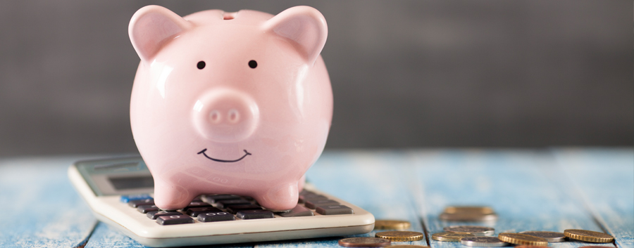 Piggy bank, calculator and coins