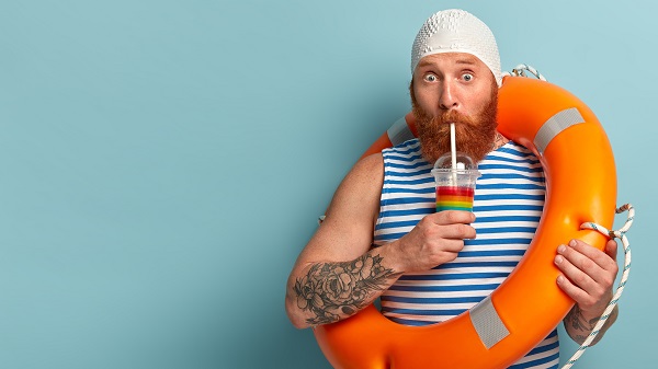 Man on holiday drinking a cocktail