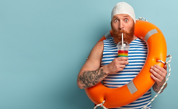 Man on holiday drinking a cocktail