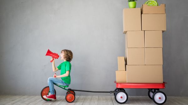 Boy on trike pulling boxes