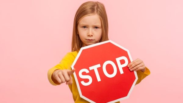Girl with stop sign