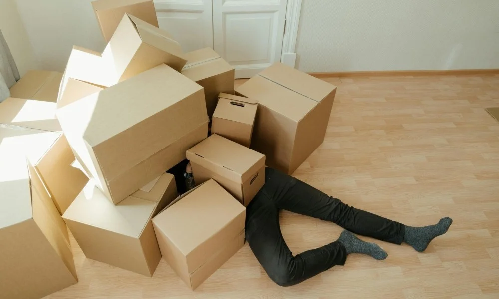 Man Under Boxes